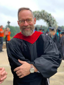 Dean DeLoach posing at graduation