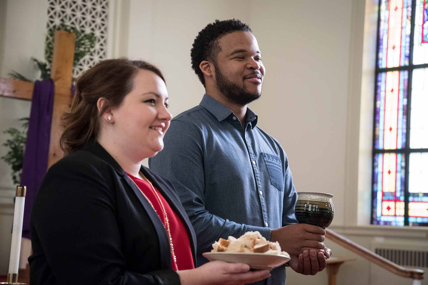 Two students serving communion