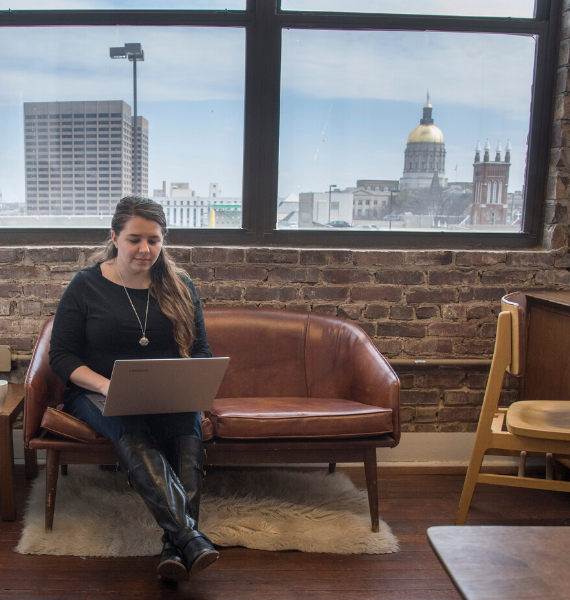 Woman sitting on couch with laptop