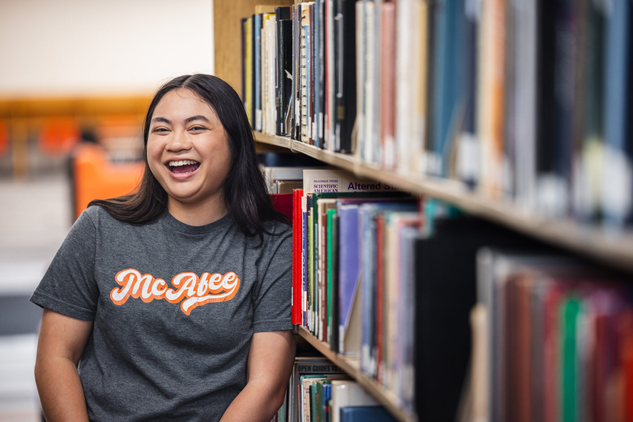student by bookshelf